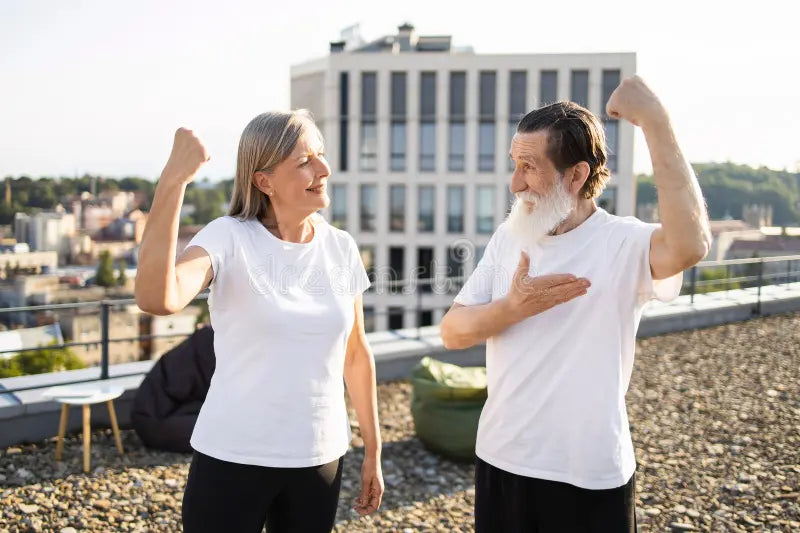 older-man-woman-showing-strength-outdoors-happy-expressions-elderly-rooftop